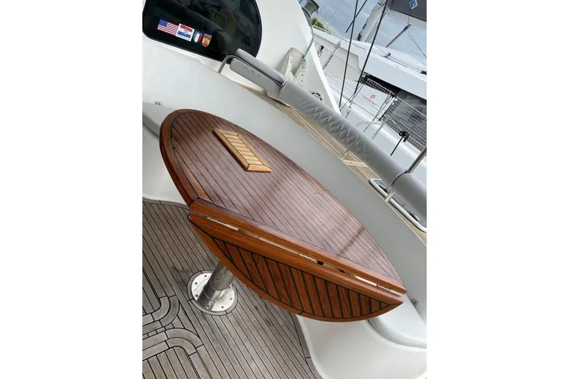Southern Pearl Yacht Photos Pics Teak table on 2001 Groupe Alliura Marine Privilege 435 yacht deck.