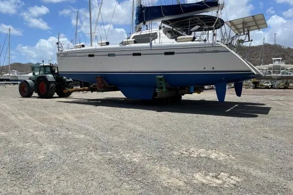 Southern Pearl Yacht Photos Pics 2001 Groupe Alliura Marine Privilege 435 catamaran on land, with tractor, under clear sky.