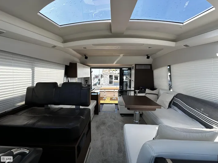  Yacht Photos Pics Luxurious interior of 2018 Prestige 460S Coupé yacht with skylights and modern seating.