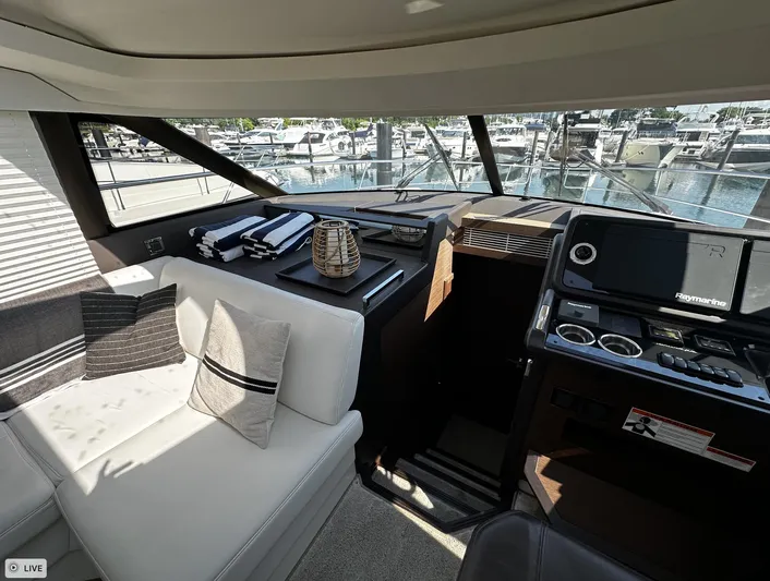  Yacht Photos Pics Interior of 2018 Prestige 460S Coupé yacht with modern seating and navigation equipment.