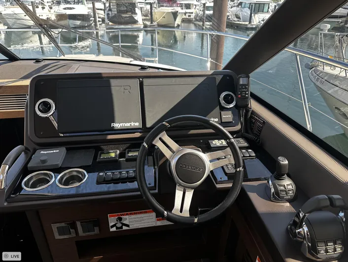  Yacht Photos Pics Cockpit of 2018 Prestige 460S Coupé yacht with steering wheel and navigation screens.