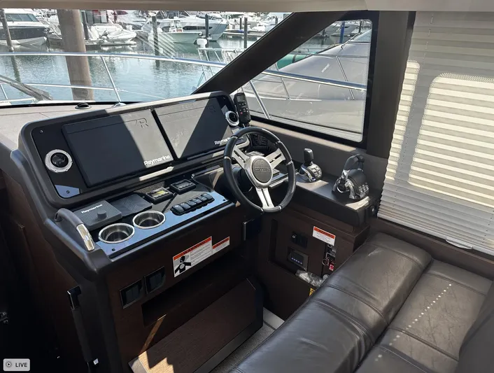  Yacht Photos Pics Interior of 2018 Prestige 460S Coupé yacht cockpit with modern controls and leather seating.
