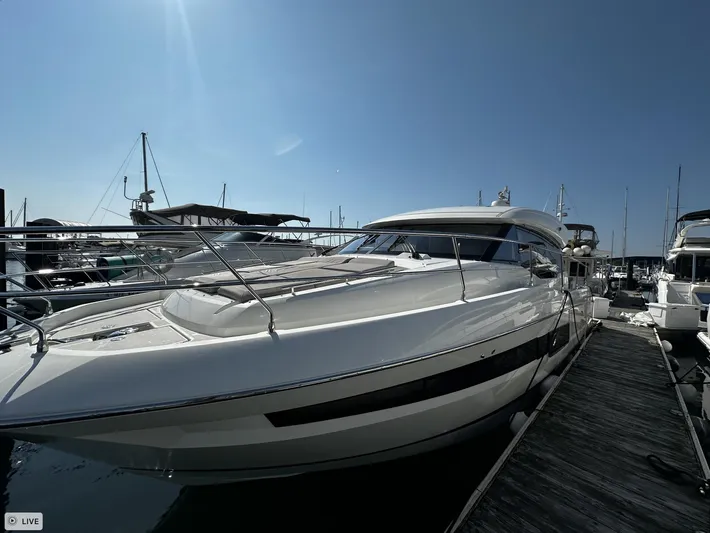  Yacht Photos Pics 2018 Prestige 460S Coupé yacht docked at marina under clear blue sky.