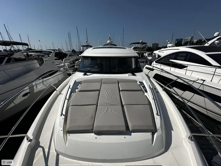  Yacht Photos Pics Prestige 460S Coupé 2018 yacht docked at marina, featuring sunbathing cushions.