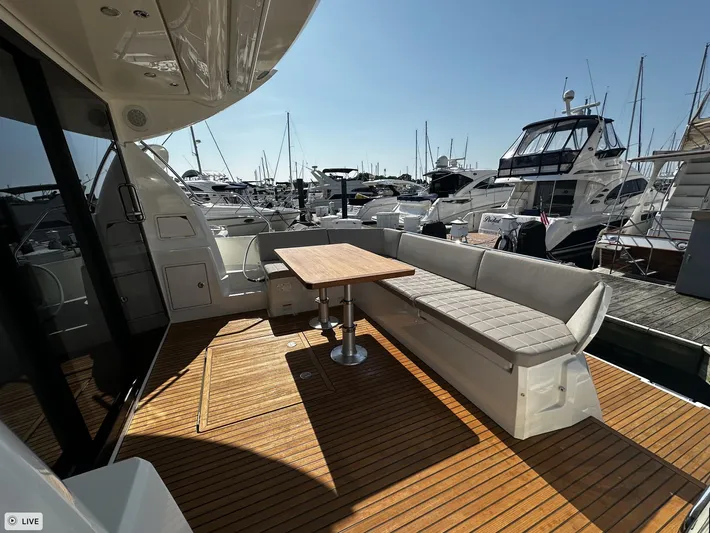  Yacht Photos Pics Prestige 460S Coupé 2018 yacht with spacious deck, wooden flooring, and marina view.