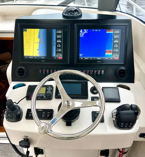 Reel Life Yacht Photos Pics Helm of 2015 Jupiter 41SB boat with dual Garmin displays and navigation controls.