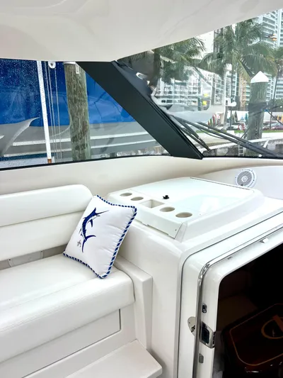 Reel Life Yacht Photos Pics Interior of 2015 Jupiter 41SB yacht with white seating and decorative pillow.