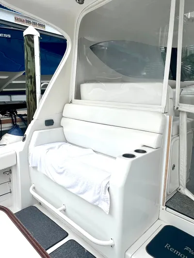 Reel Life Yacht Photos Pics White seating area on a 2015 Jupiter 41SB boat with towel and cup holders.