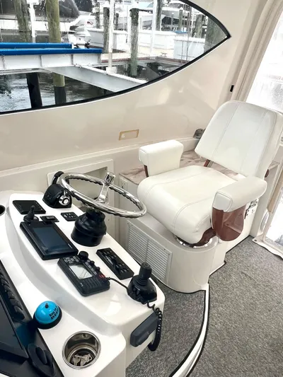 Reel Life Yacht Photos Pics Helm of 2015 Jupiter 41SB boat with steering wheel and navigation controls.