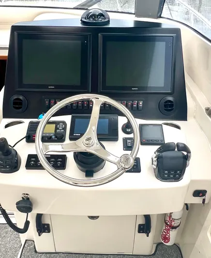 Reel Life Yacht Photos Pics Helm of 2015 Jupiter 41SB boat with dual screens and navigation controls.