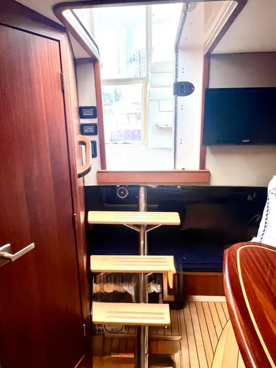 Reel Life Yacht Photos Pics Interior of a 2015 Jupiter 41SB yacht with wooden stairs and modern design.