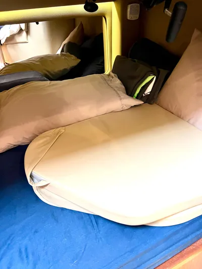 Reel Life Yacht Photos Pics Cozy cabin bed with pillows in a 2015 Jupiter 41SB boat.