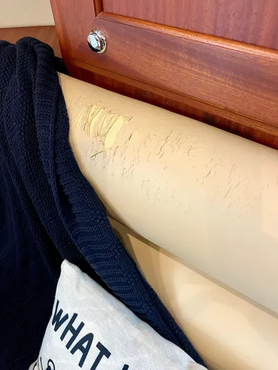 Reel Life Yacht Photos Pics Damaged leather seat in 2015 Jupiter 41SB boat interior with blanket and pillow.