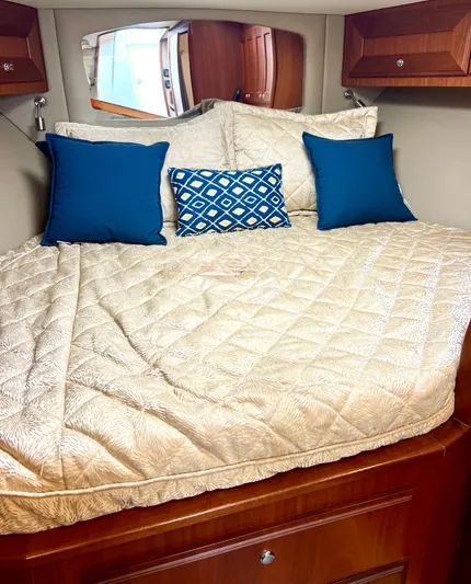 Reel Life Yacht Photos Pics Luxurious bed in 2015 Jupiter 41SB yacht cabin with blue accent pillows.