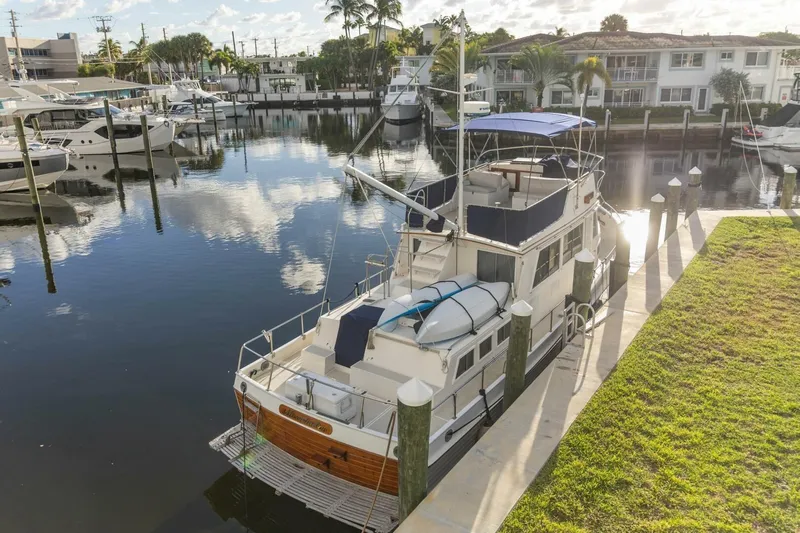 Moonshadow Yacht Photos Pics 1985 Grand Banks 42 Classic yacht docked in a serene marina setting.