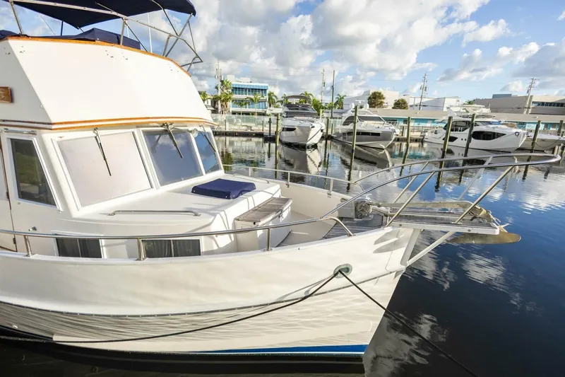 Moonshadow Yacht Photos Pics 1985 Grand Banks 42 Classic yacht docked in a marina under a partly cloudy sky.