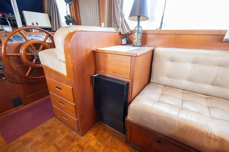 Moonshadow Yacht Photos Pics Interior of 1985 Grand Banks 42 Classic yacht with wooden helm and seating area.