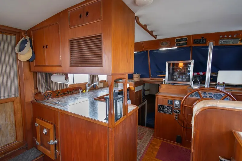 Moonshadow Yacht Photos Pics Interior of 1985 Grand Banks 42 Classic yacht with wooden cabinetry and helm station.