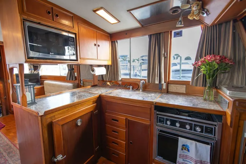 Moonshadow Yacht Photos Pics Interior of 1985 Grand Banks 42 Classic yacht kitchen with wood cabinetry and modern appliances.