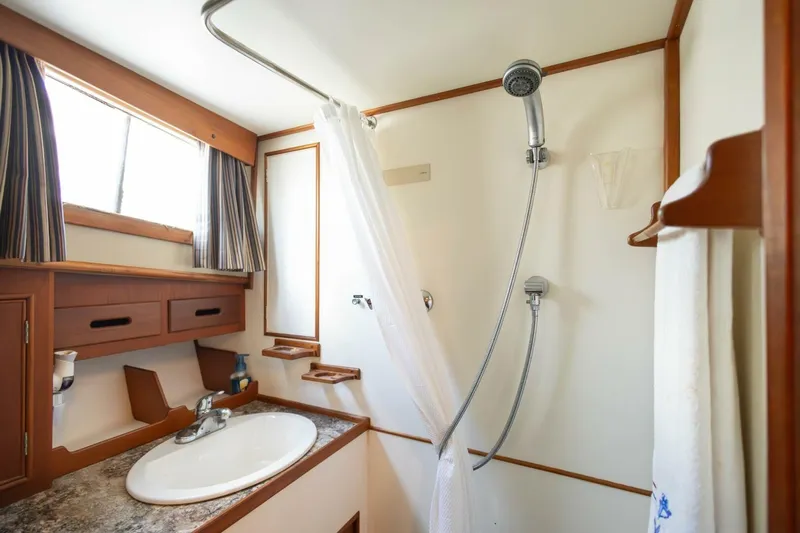 Moonshadow Yacht Photos Pics Bathroom interior of 1985 Grand Banks 42 Classic yacht, featuring shower and sink.