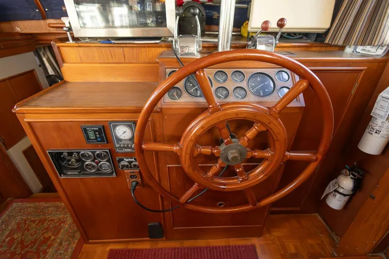 Moonshadow Yacht Photos Pics 1985 Grand Banks 42 Classic helm with wooden wheel and instrument panel.