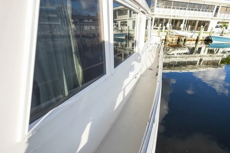 Moonshadow Yacht Photos Pics 1985 Grand Banks 42 Classic yacht docked, reflecting on calm water.