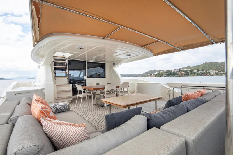  Yacht Photos Pics Luxurious 2014 Custom Line Navetta 26 Crescendo yacht with spacious outdoor seating and dining area.