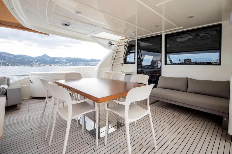  Yacht Photos Pics Luxurious 2014 Custom Line Navetta 26 Crescendo yacht deck with dining area and scenic views.