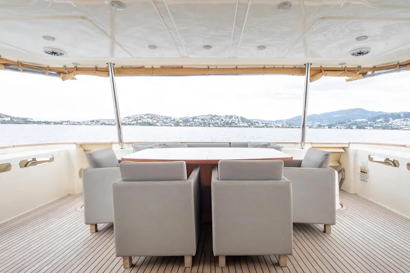  Yacht Photos Pics Luxurious 2014 Custom Line Navetta 26 Crescendo yacht deck with elegant seating and scenic ocean view.