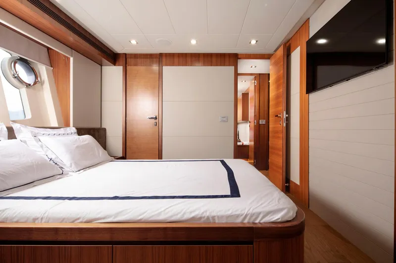  Yacht Photos Pics Luxurious bedroom interior on 2014 Custom Line Navetta 26 Crescendo yacht, featuring elegant wood finishes.