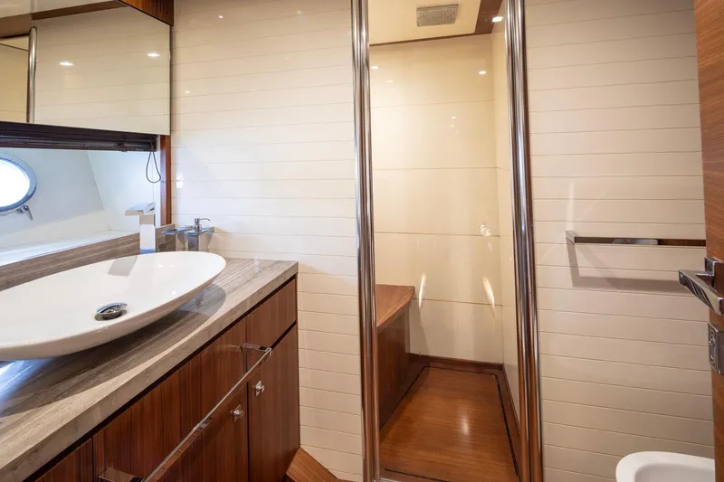  Yacht Photos Pics Luxurious bathroom on 2014 Custom Line Navetta 26 Crescendo yacht, featuring modern sink and wood accents.
