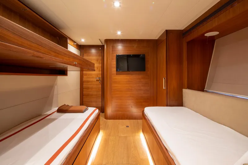  Yacht Photos Pics Luxurious 2014 Custom Line Navetta 26 Crescendo yacht cabin with twin beds and wood paneling.