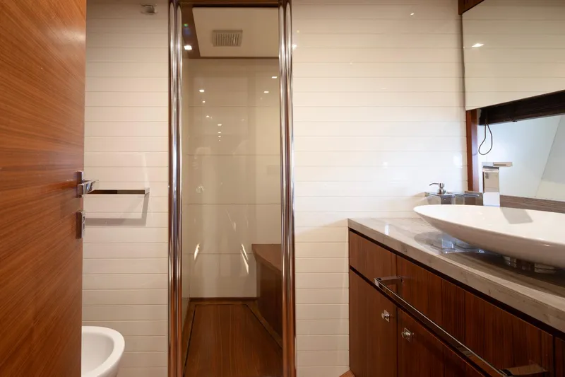  Yacht Photos Pics Luxurious bathroom on 2014 Custom Line Navetta 26 Crescendo yacht, featuring modern fixtures and elegant wood finishes.