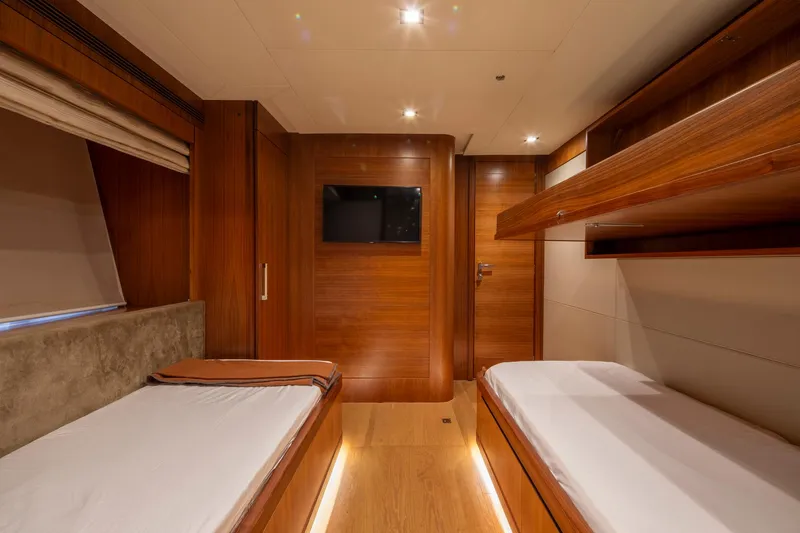  Yacht Photos Pics Luxurious interior of 2014 Custom Line Navetta 26 Crescendo yacht with twin beds and wood finish.
