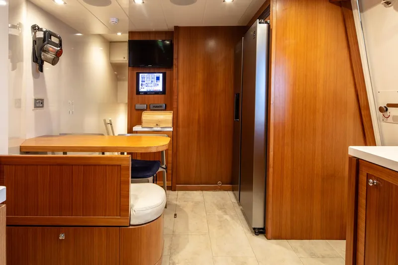  Yacht Photos Pics Luxurious interior of 2014 Custom Line Navetta 26 Crescendo yacht with wood finishes and modern amenities.
