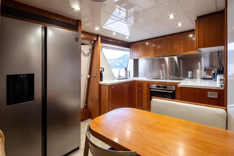  Yacht Photos Pics Luxurious kitchen interior of 2014 Custom Line Navetta 26 Crescendo yacht with modern appliances.
