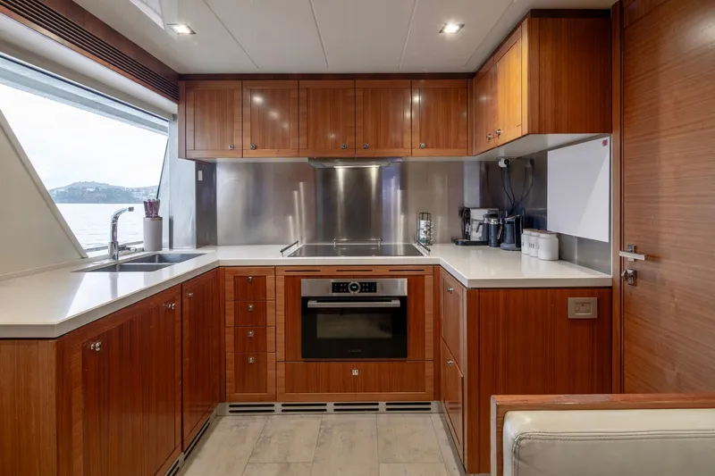  Yacht Photos Pics Luxurious 2014 Custom Line Navetta 26 Crescendo yacht kitchen with modern wood cabinetry.