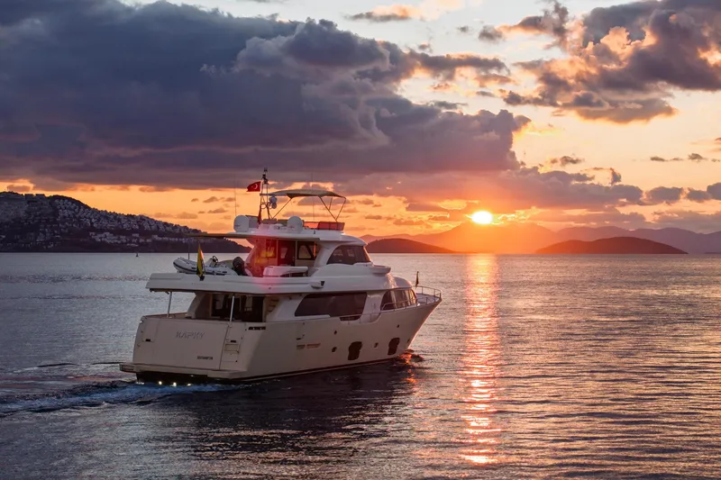  Yacht Photos Pics Luxury yacht Navetta 26 Crescendo cruising at sunset, 2014 model, serene ocean view.