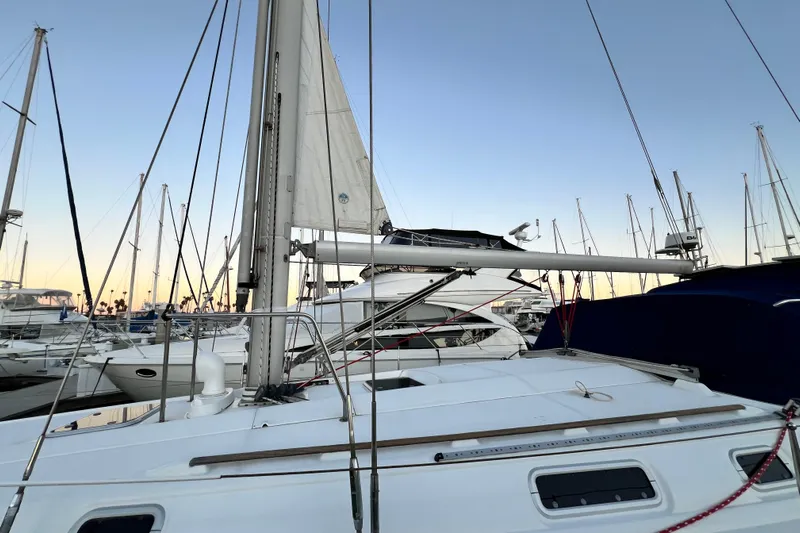 Alpha Carina Yacht Photos Pics Sailboat Beneteau Oceanis 440, 1993 model, docked at marina during sunset.