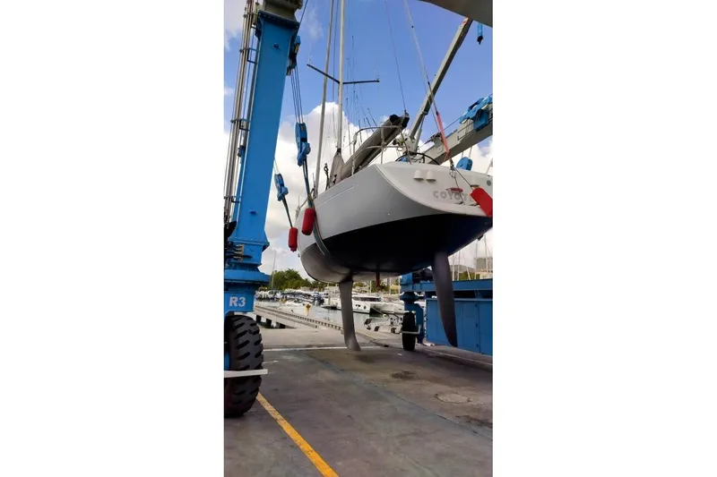  Yacht Photos Pics 2004 Beneteau First 40.7 sailboat being lifted at a marina.