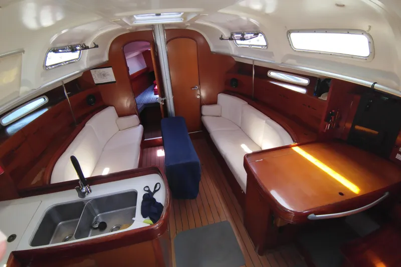  Yacht Photos Pics Interior of 2004 Beneteau First 40.7 yacht with elegant wood finish and cozy seating.