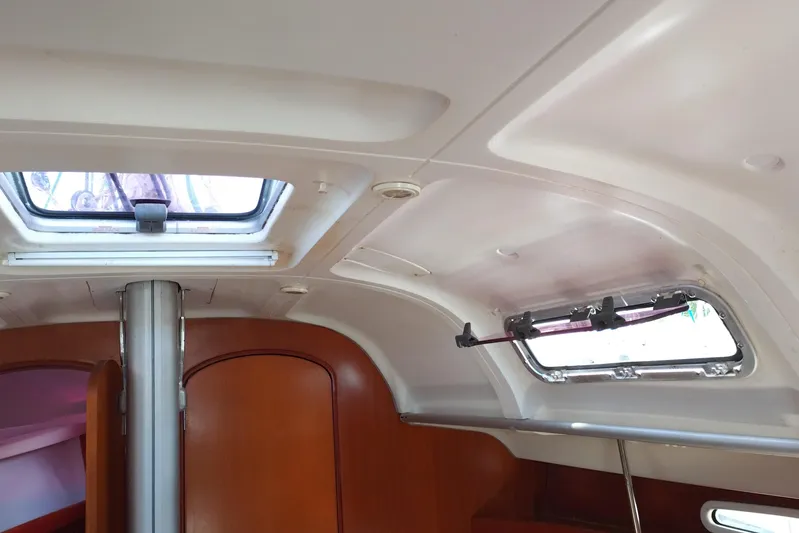  Yacht Photos Pics Interior cabin of 2004 Beneteau First 40.7 sailboat with skylight and wooden finish.