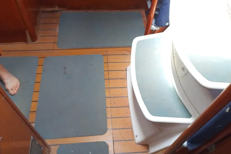  Yacht Photos Pics Interior of 2004 Beneteau First 40.7 sailboat with wooden flooring and steps.