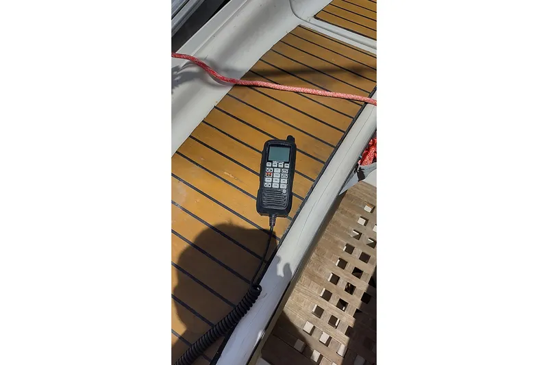  Yacht Photos Pics Handheld radio on teak deck of 2004 Beneteau First 40.7 sailboat.