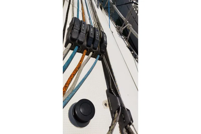  Yacht Photos Pics Deck rigging on a 2004 Beneteau First 40.7 sailboat, featuring colorful ropes and cleats.