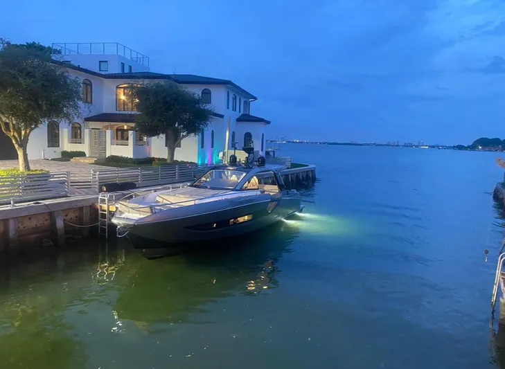  Yacht Photos Pics Azimut Verve 47 yacht docked by a waterfront house at dusk, 2021 model.