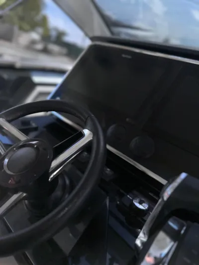  Yacht Photos Pics 2021 Azimut Verve 47 yacht cockpit with steering wheel and navigation display.