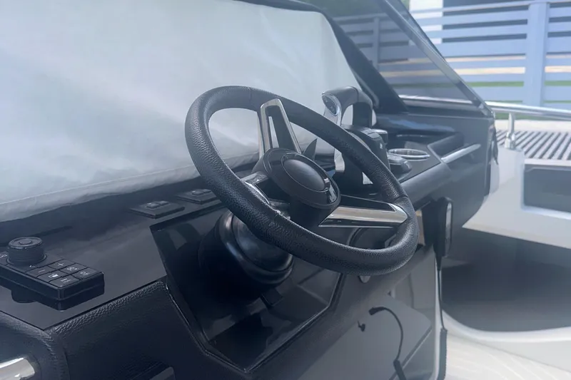  Yacht Photos Pics Steering wheel of 2021 Azimut Verve 47 yacht, sleek black dashboard design.