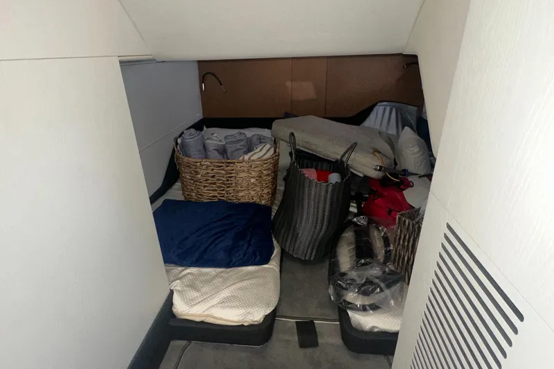  Yacht Photos Pics 2021 Azimut Verve 47 cabin storage area with baskets and bedding.
