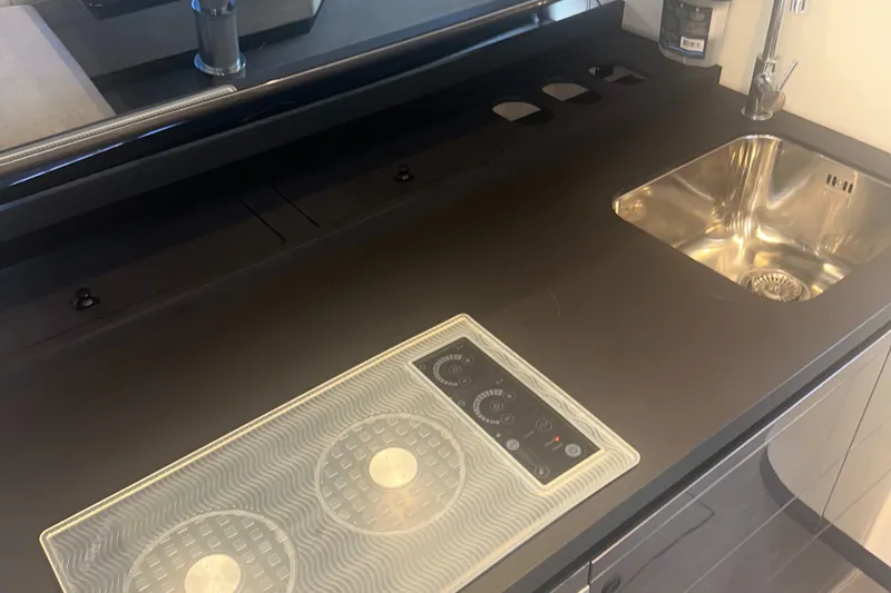  Yacht Photos Pics Modern kitchen area on 2021 Azimut Verve 47 yacht with sleek sink and cooktop.